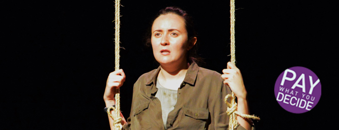 A woman with dark hair holds a hanging rope in either hand