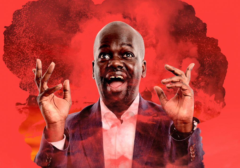 Daliso Chaponda stands in a mushroom cloud on a red background, he's pulling a silly face