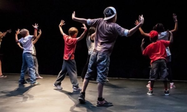 A group of young people practcising street dance on stage
