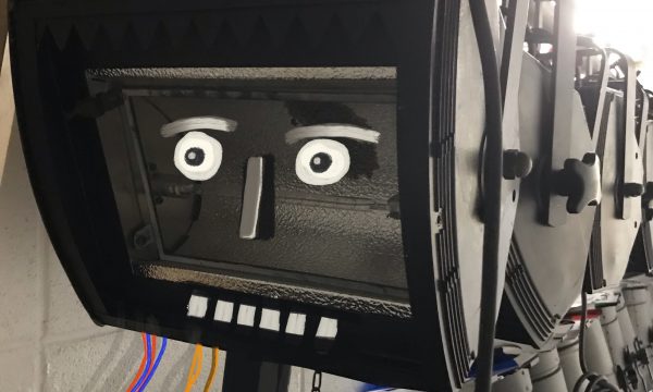 A theatre light with a surprised face painted in