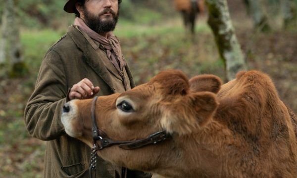 Man in a cowboy hat with a cow