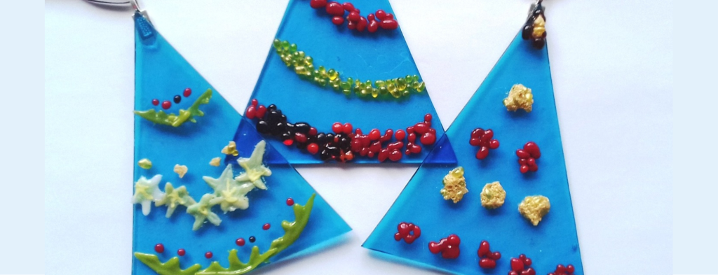 Blue glass christmas trees, decorated with multicolour fused glass.