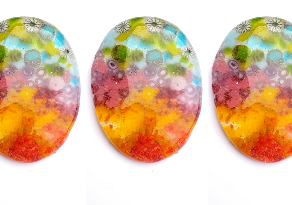 A series of three multicoloured glass Easter eggs
