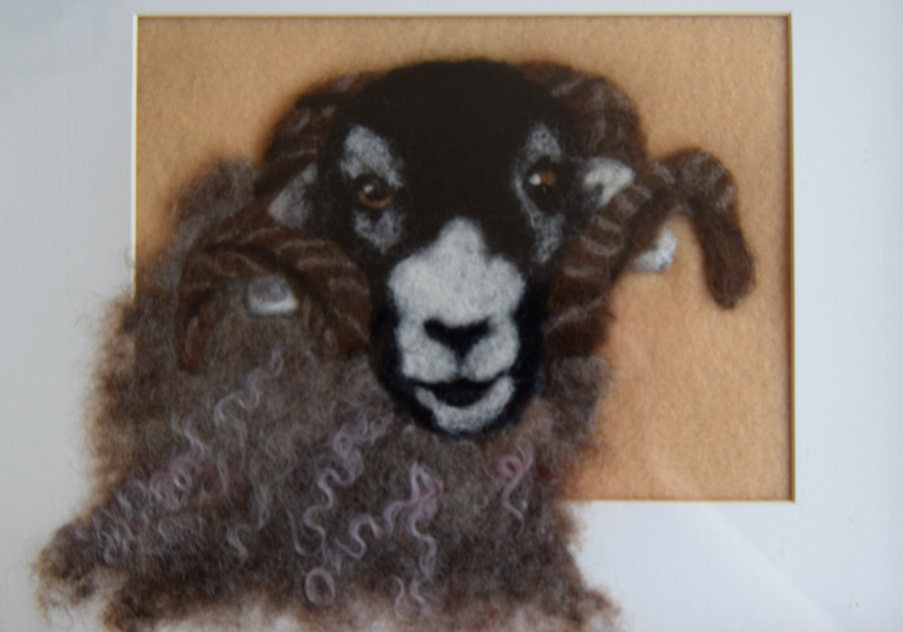 A felted portrait of a sheep.