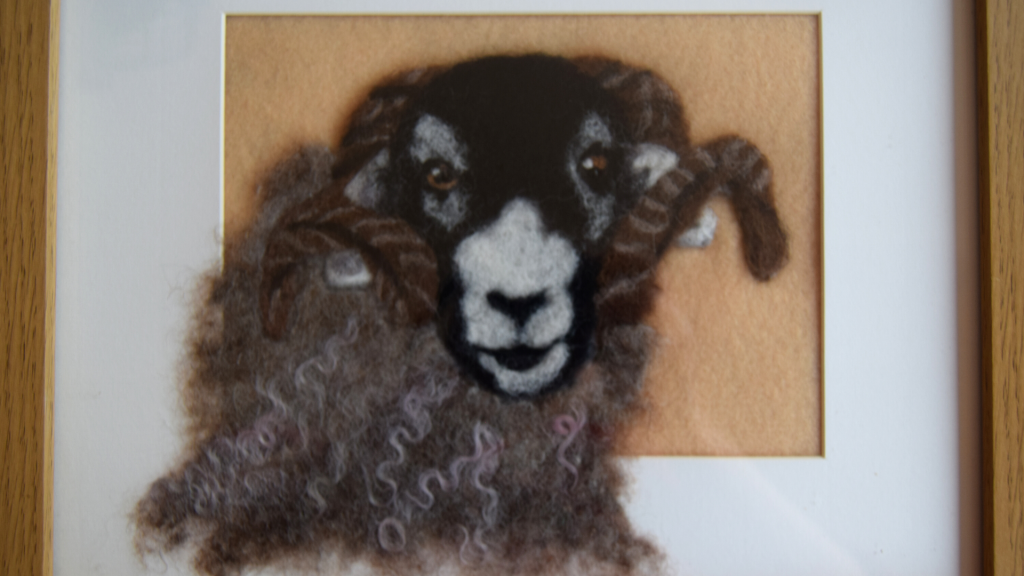 A felted portrait of a sheep.