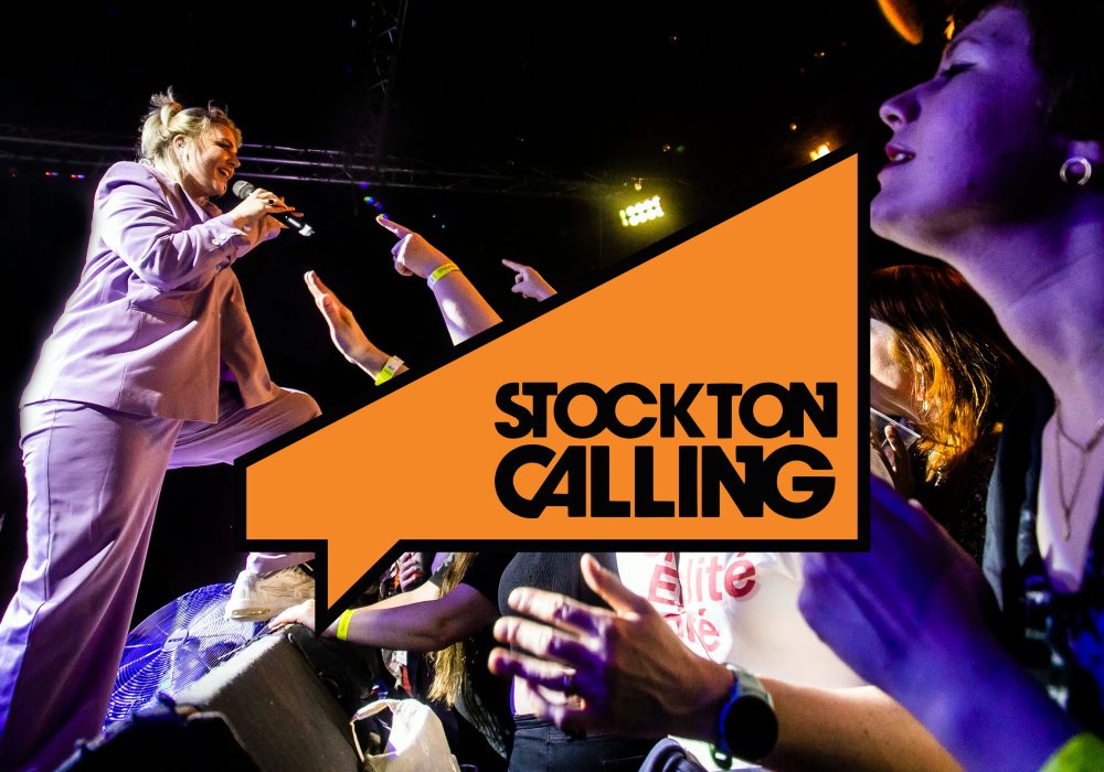 Self Esteem performing to crowd with Stockton Calling logo centre point to the image