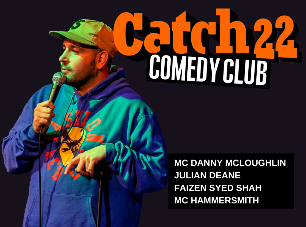Comedian Danny McLoughlin stands to the left of an orange Catch 22 logo.