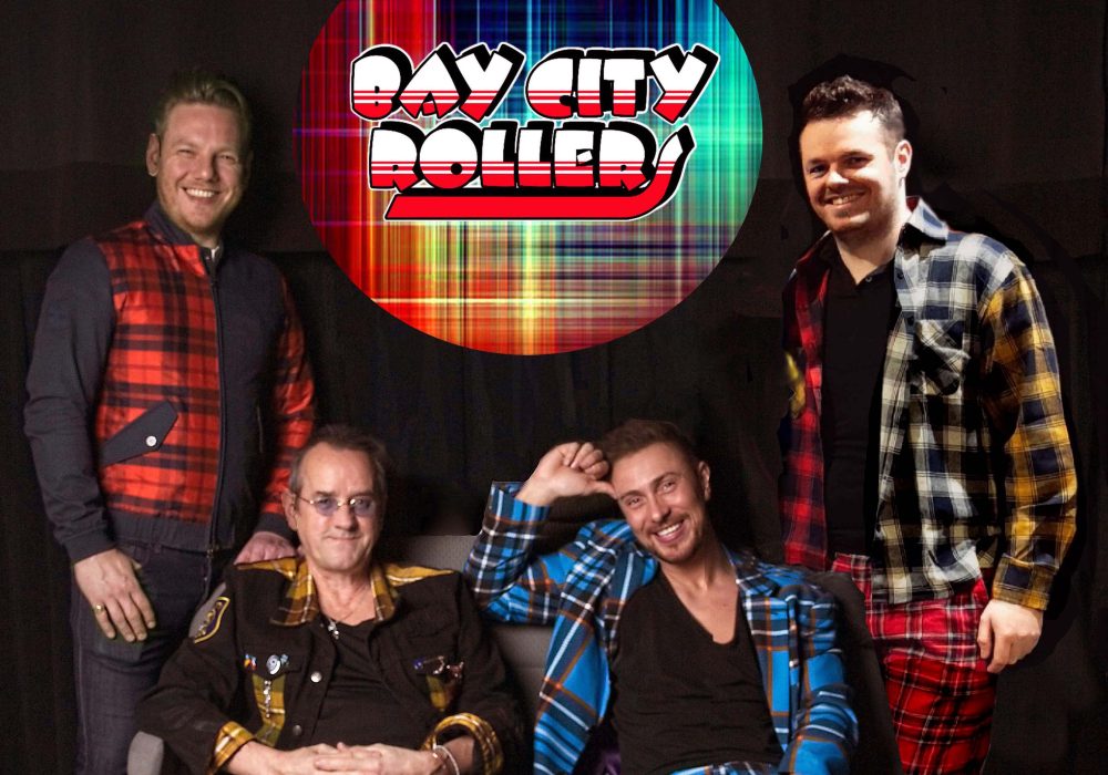 4 members of Bay City Rollers smiling and looking happy
