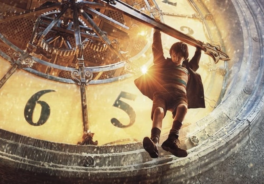 A young person hangs from the hand on a large clock face