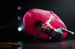 Luca wrestles with a large, pink inflatable cushion