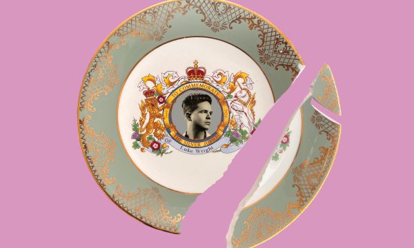 A broken commemorative style china plate, with a picture of Luke in the centre circle, and words around it that read 'To commemorate the Silver Jubilee of Luke Wright. A heraldic lion and unicorn appear either side of this circle.