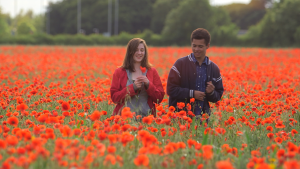 girl and boy amongst a poppy field