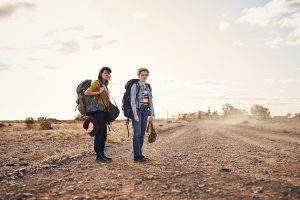 Two friends in remote Australia with backpacks.