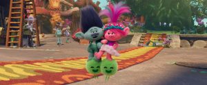 Two Trolls one blue one pink floating on green fluffy orbs