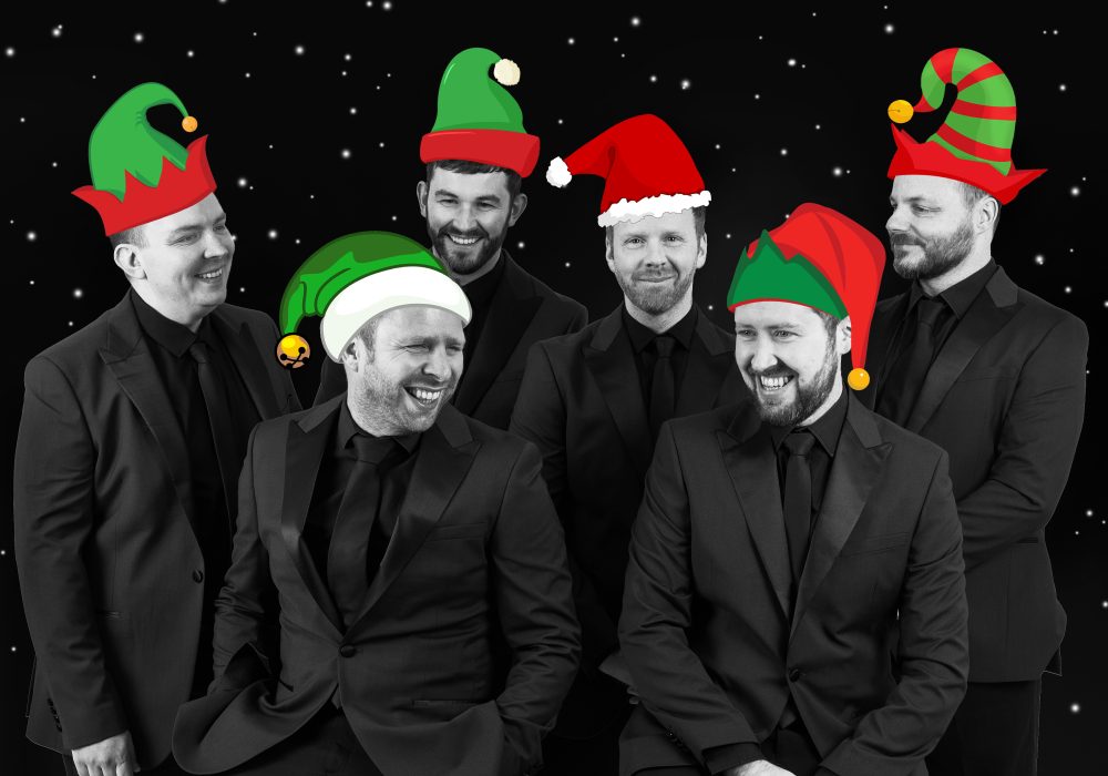 The Funk Collective band all together with Christmas items on their faces and heads