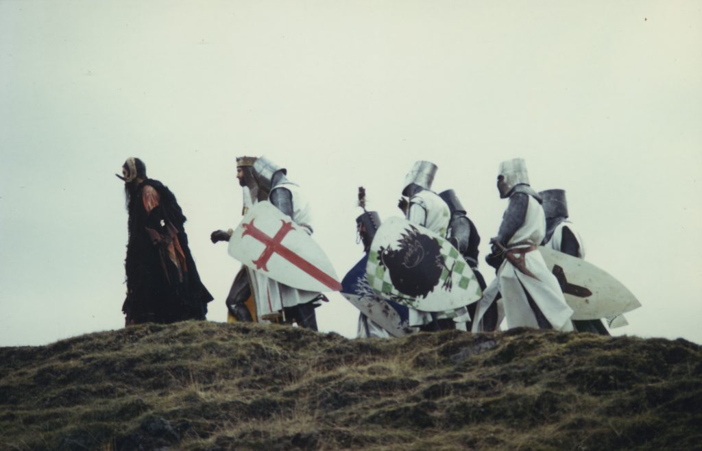 A group of knights on a journey over a hill