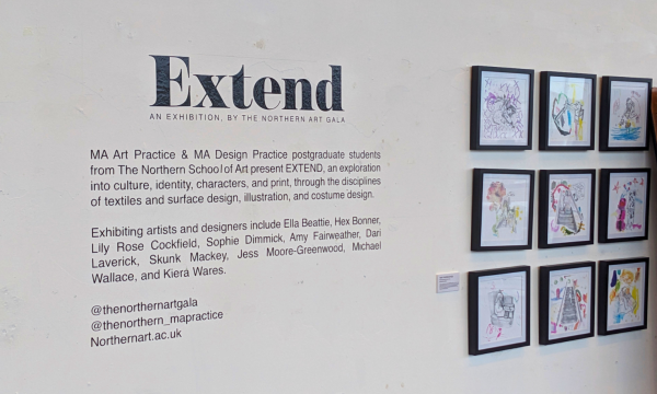 A photo of a white gallery wall, featuring exhibiton text, and nine framed prints.