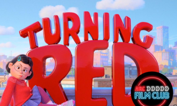 Bright red letters spelling out "Turning Red" with one of the main characters sat infront of it