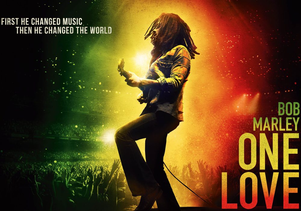 Bob Marley, lit up with green, yellow and red performing.