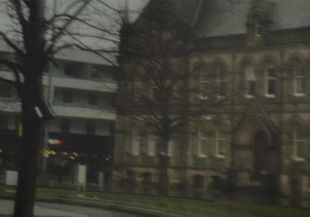 Blurred, gloomy looking shot of Middlesbrough Town Hall and Centre Square, with the Holiday Inn in the background