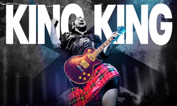 King King guitarist in front of the words King King