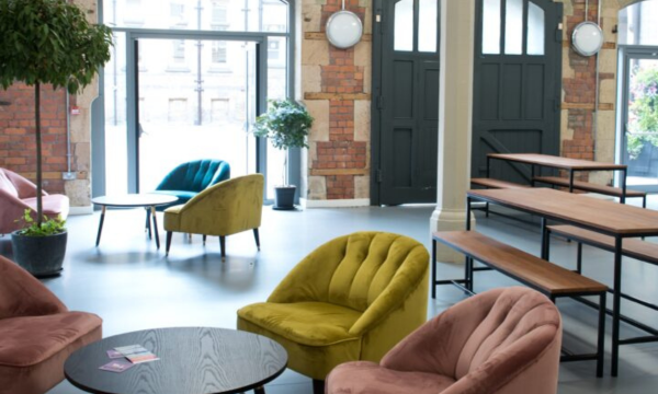 Interior of the Old Fire Station space at Middlesbrough Town Hall, with a mix of styles of casual seating and tables/benches.