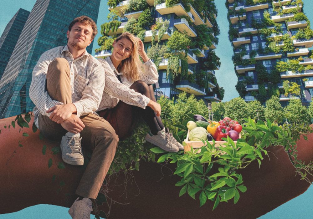 A white male with short fair hair wearing a white shirt and brown trousers sat on a wall with one knee up. Next to him is a white female with long blonde hair dressed the same with her knees up. The background shows high-rise buildings depicted with flowers.