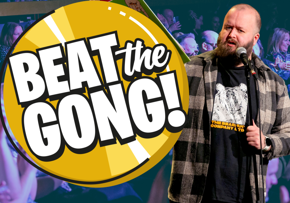 Comedian Freddy Quinne standing to the right of an animated Beat the Gong logo.