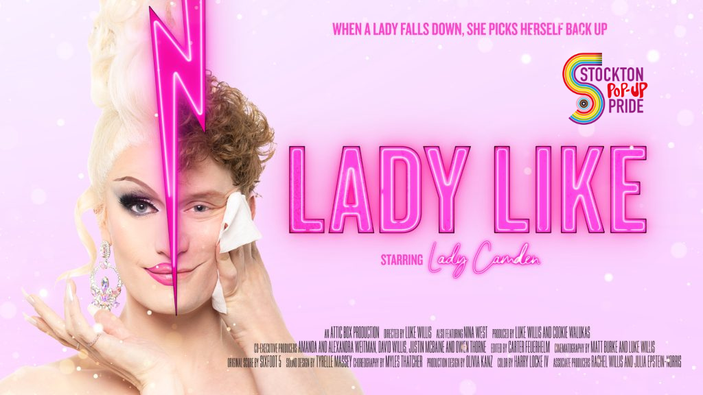 Pink background and Lady Like in pink text. A image of Lady Camden a drag queen, right half of a face natural a male with ginger curly hair separated by a lightning bolt and the left side is in drag make up, with white blonde hair. Image also shows the Stockton Pop-Up Pride logo.