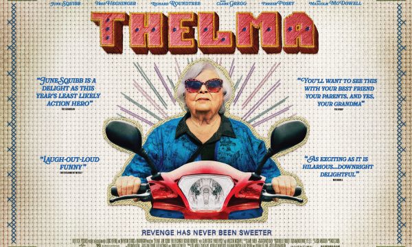 White older woman with bobbed white/grey hair wearing sun glasses and a blue top. She is sat on a red scooter with a cross-stitch background saying Thelma.