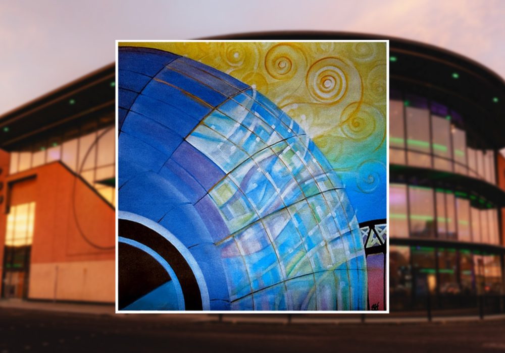 The main focus is a colourful artistic rendering or painting in the foreground. This artwork depicts a large blue curved structure, possibly representing part of a building or architectural element. It has a grid-like pattern of translucent panels, giving it a glass-like appearance. The background of this painting transitions from blue to yellow, with swirling spiral patterns in the yellow area, reminiscent of a stylized sky or abstract design. The background of the overall image shows part of a real building. It appears to be a modern structure with large windows, possibly a commercial or public building. The visible portion is predominantly orange or terracotta in colour, with some green lighting visible.