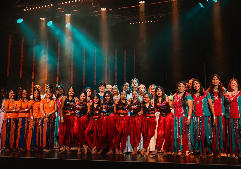 Photo shows ensemble of dancers who perform as part of the festival of light and colour in Stockton, all wearing traditional Indian garments,